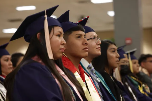 Students standing at a convocation ceremony.